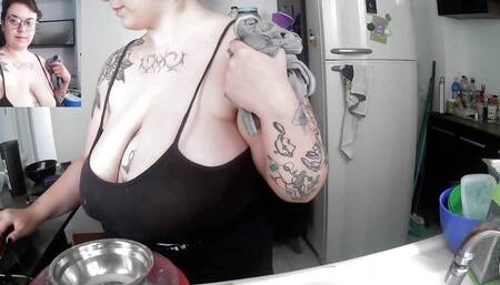 tattoed milf doing the dishes with too much cleavage