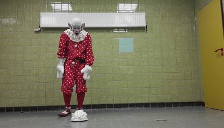 Clown taking a Pie in the Face in a public sports club