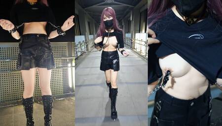 Handcuffs connected to nipple clamps outdoors