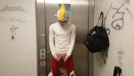 Clown jerking off and putting on condom in public restroom