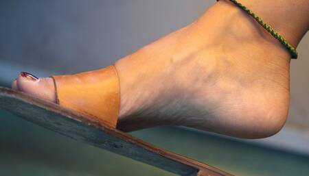 Foot fetish and slippers dangling close-up