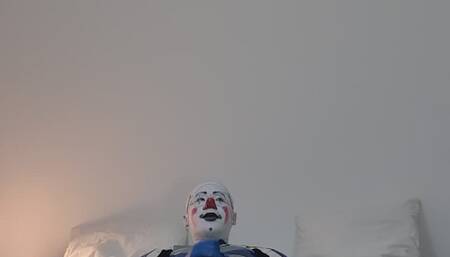 Clown in leather suit is jerking off himself