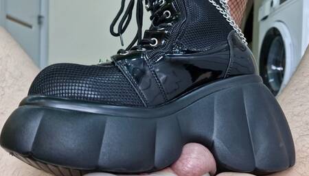 Ballbusting, trampling balls and cock in chastity belt. Dominatrix Nika kicks balls and tramples them in her boots.