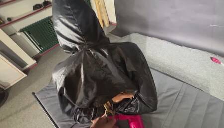 Marie Mueller bound and gagged in shiny nylon Rainwear trying to escape