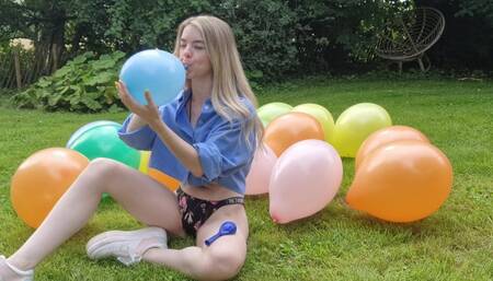 Adorable girl stomps balloons