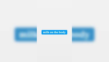 milk on the body, squeezing the breasts in milk