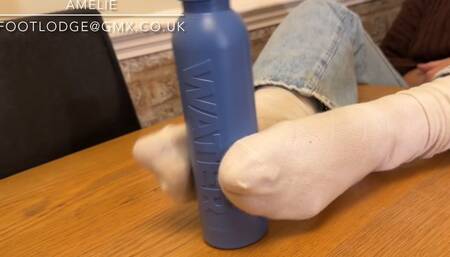 Playing with a water bottle using just my feet in dirty white socks