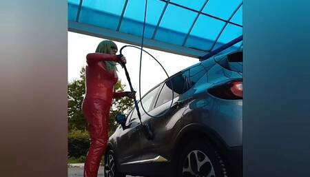 At the car washing station in red vinyl outfit