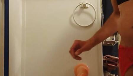 The lady moans and cum shots standing, without hands from the dildo in the ass)