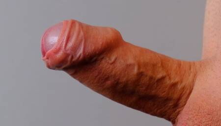 Man masturbating flaccid cock and playing with his foreskin becoming erect close-up