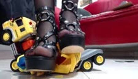 crush a truck with excavator in nylons wearing heels and wooden sandals