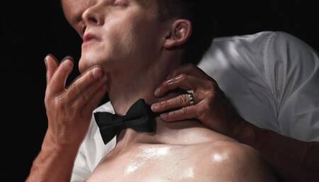 Master Saint rubbing massage oil over Dylan Tides