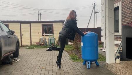 girl in extremely high heels ballet boots walking around the backyard and getting her heels dirty