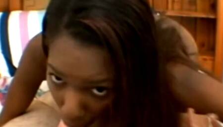 A lovely ebony hottie sucking his small white cock