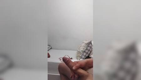Sexy smooth masturbates cock in toilet