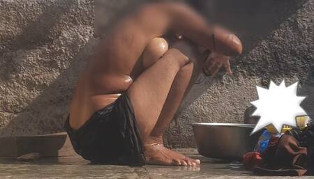 The stepsister is bathing naked in an open bathroom in the village