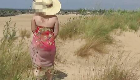 Naked hot MILF on a nude beach.