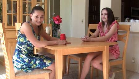 A strip Liars Dice game ends with both girls satisfying each other on the bed