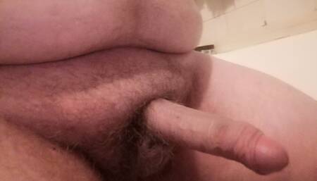 Young chubby bear is jerking on the bed