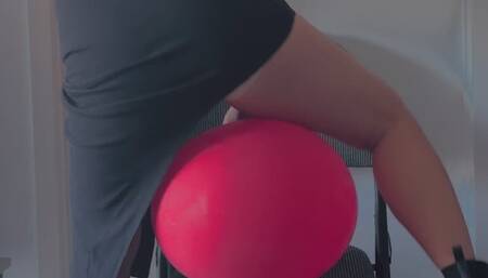 Chubby girl in a dress tries to pop a balloon