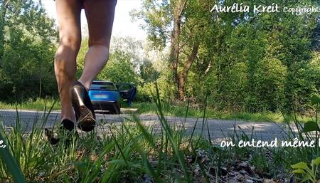 I clean the windows of my car on the side of the road in a minidress with an anal plug