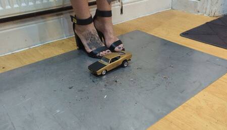 Giantess Atari queen destroys a Plymouth Barracud toy car crush in sexy black heels closeup left view