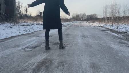 A girl in high-heeled boots decided to walk along the road, but her shoes slipped very much on the ice, so she sometimes even fell