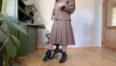 tacher in woolen costume toe tapping in leather boots mov