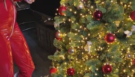 Christmas tree decorating in red, hot jumpsuit with Hunterboots