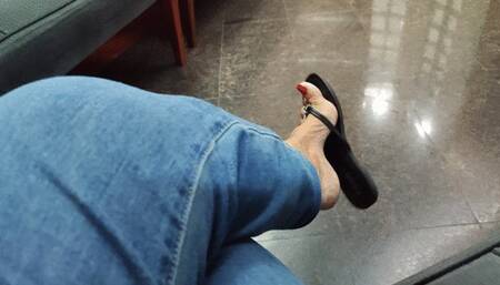 Legs crossed and flip-flops dangling from the feet (1)