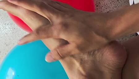 Creamy bare feet popping balloons