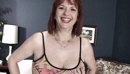 Sweet redhead Angie Summers shows off her naked shape