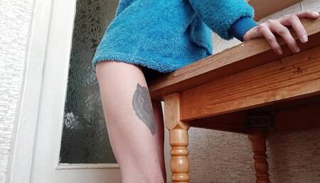 Skinny brunette rubs her pussy on the table in the kitchen