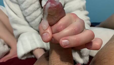 His girlfriend oils up his cock to give him a handjob he won't soon forget.