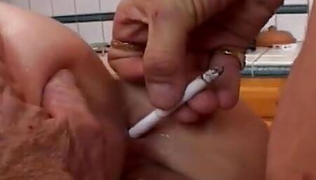 Dirty Slut Smokes While Older Man Licks and Pumps Her Pierced Pussy on the Kitchen Table