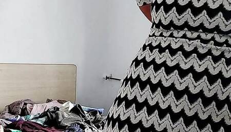 Sexy brunette tries on clothes naked. I am watching a woman undressing