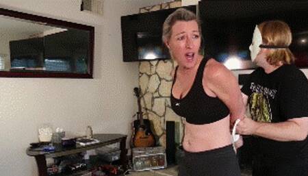 Amanda Kent, a fit MILF blonde gets tightly hogtied and ballgagged before her morning cycling routine