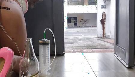 Tattooed ass sissy giving herself a 1l beer enema at the open door