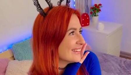 Gorgeous redhead in a bright blue sweater Bunny poses hotly