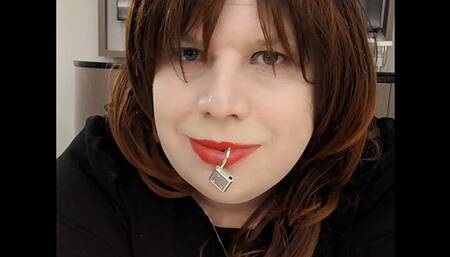 Sissy Kelli walks a hotel corridor wearing a penis gag