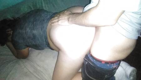 To my girlfriend in a gray shirt, I pull down her pants and put her in bed as a doggy