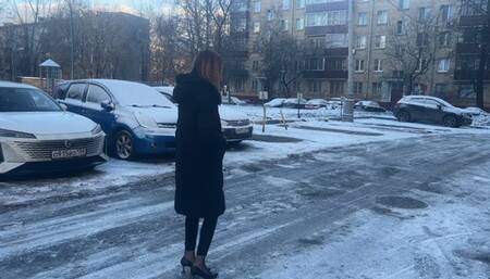 The girl went out for a walk in high heels, but she did not expect that it would be so slippery and there would be ice everywhere