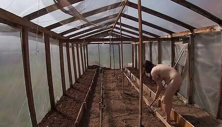 Nude house wife working in the greenhouse