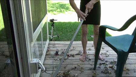 Lilly sweeping the porch barefooted