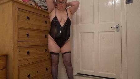 striptease in PVC bodice and fishnet holdup stockings