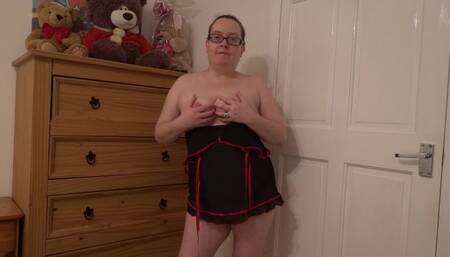 Striptease in Blank Pink Bodice Playing with Breasts