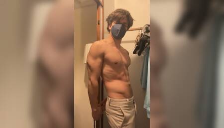 Young bodybuilder flexing and stripping down