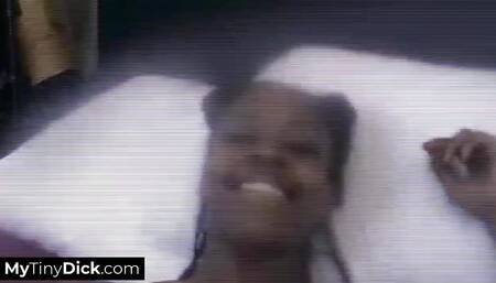 A sexy ebony babe is sucking his small white dick on the bed